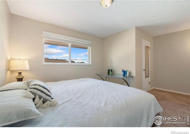 carpeted bedroom with a textured ceiling