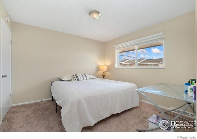 carpeted bedroom with a textured ceiling