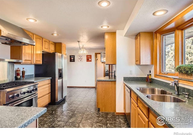 kitchen with pendant lighting, appliances with stainless steel finishes, a textured ceiling, extractor fan, and sink