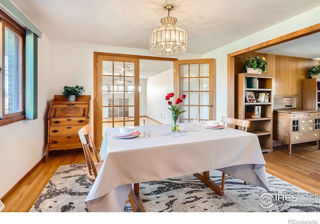 dining room with light hardwood / wood-style flooring and a chandelier