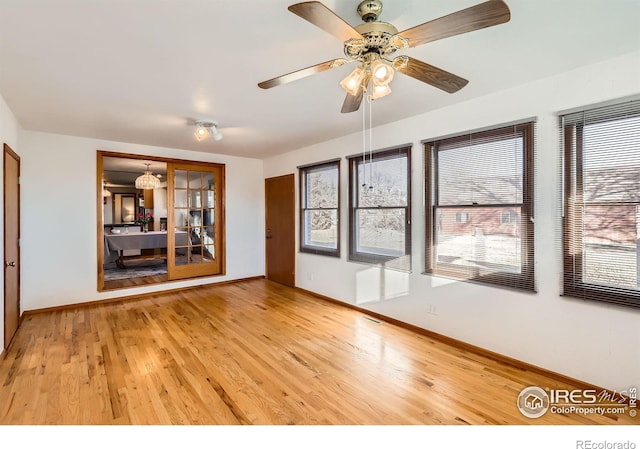 empty room featuring ceiling fan and hardwood / wood-style flooring