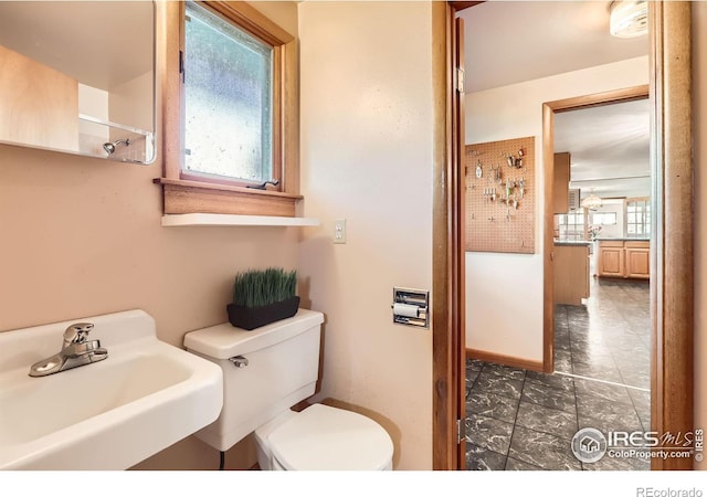 bathroom featuring toilet and sink