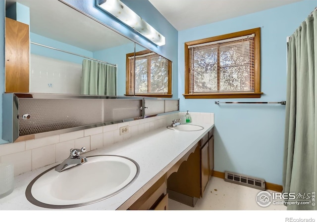 bathroom with decorative backsplash and vanity