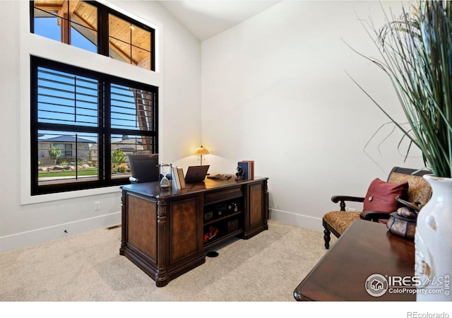 office space with light colored carpet and lofted ceiling