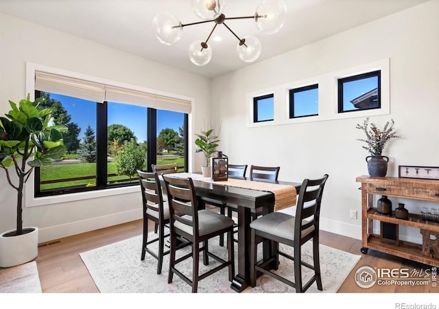 dining area featuring a chandelier and hardwood / wood-style flooring