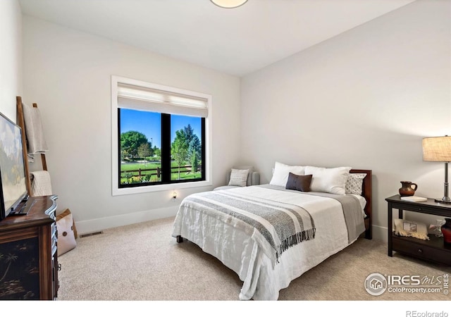 bedroom featuring light colored carpet