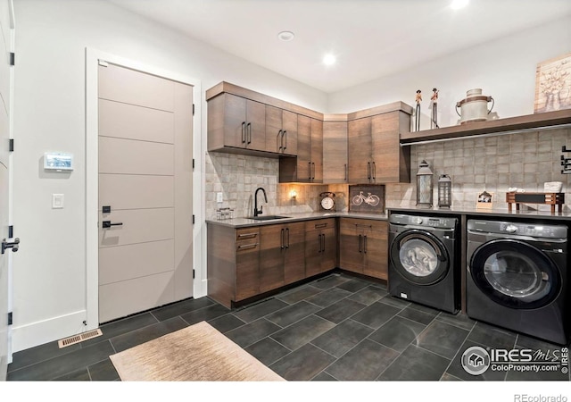 laundry room featuring washing machine and dryer and sink