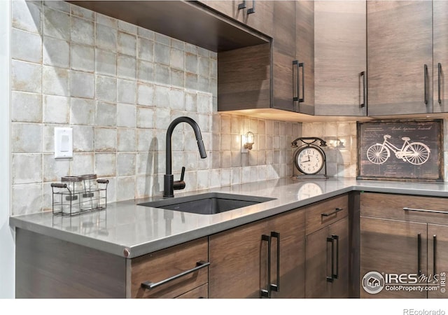 kitchen featuring sink and backsplash