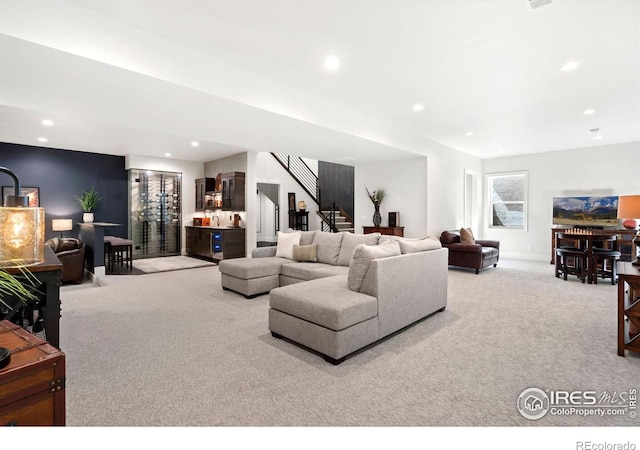 living room with bar and light colored carpet