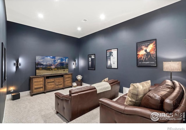 cinema room featuring light colored carpet