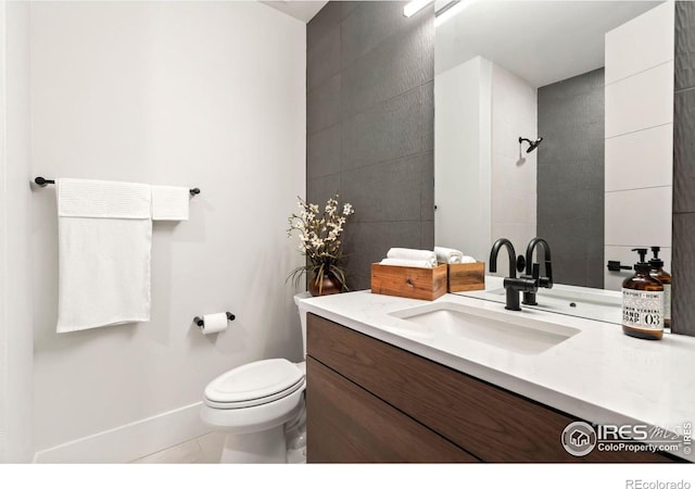 bathroom with tile patterned floors, vanity, and toilet