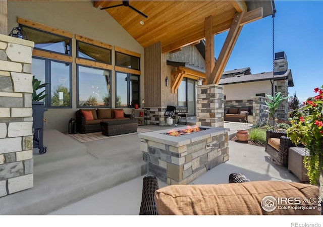 view of patio featuring ceiling fan, an outdoor living space with a fire pit, and area for grilling