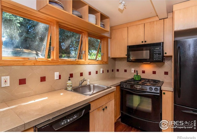 kitchen with black appliances, backsplash, sink, and light brown cabinets