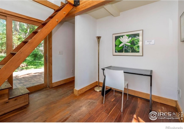 home office featuring dark hardwood / wood-style flooring and beamed ceiling