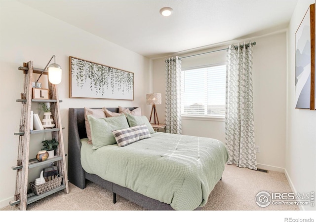 bedroom with light colored carpet