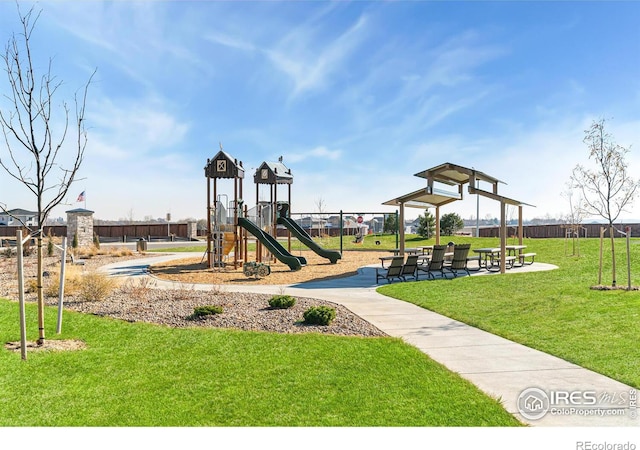 view of playground with a lawn