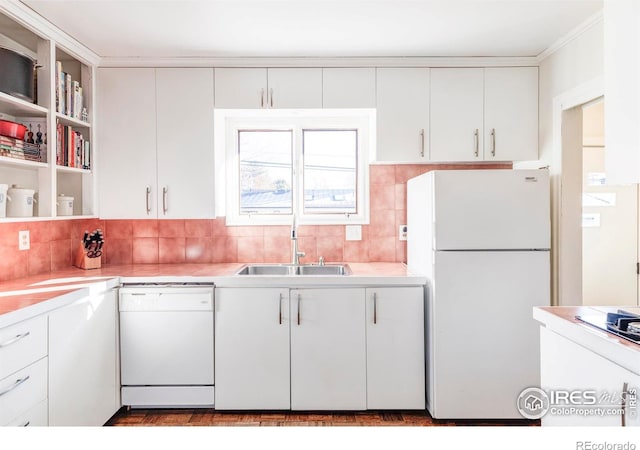 kitchen with white cabinetry, sink, white appliances, and backsplash