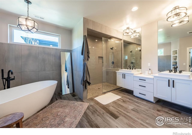 bathroom featuring hardwood / wood-style floors, vanity, and independent shower and bath