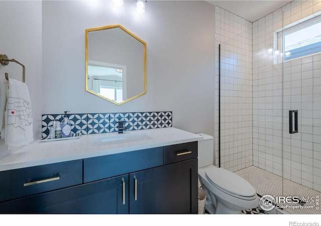 bathroom with an enclosed shower, vanity, and toilet