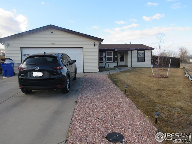 single story home featuring a front yard and a garage