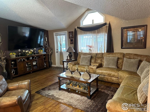 living room featuring vaulted ceiling, a textured ceiling, and wood-type flooring