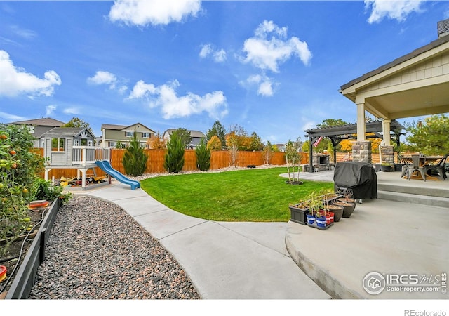 view of yard with a playground, a patio, and a pergola