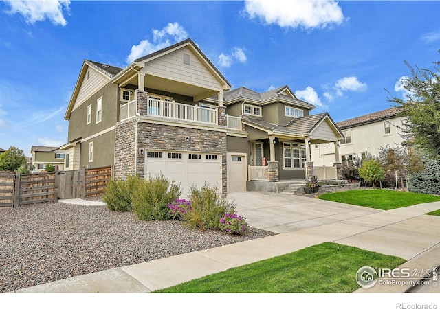 view of front of home with a balcony, a garage, and covered porch