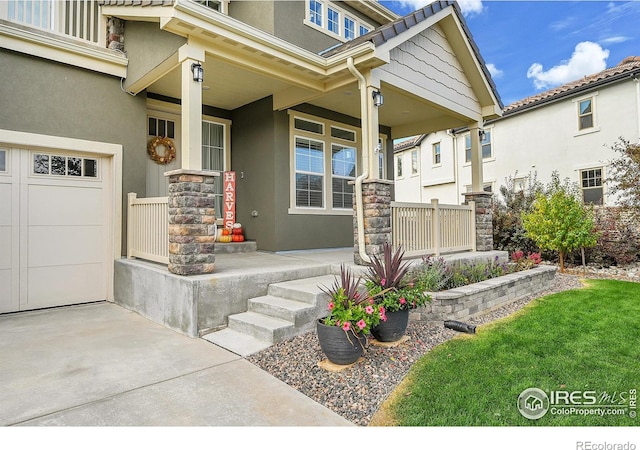 entrance to property with a garage and covered porch