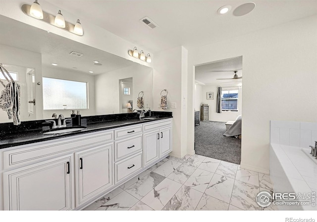 bathroom with ceiling fan and vanity