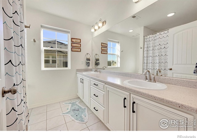 bathroom with vanity, curtained shower, and tile patterned floors