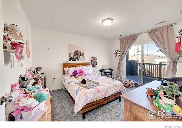 bedroom featuring dark carpet, access to outside, and a textured ceiling