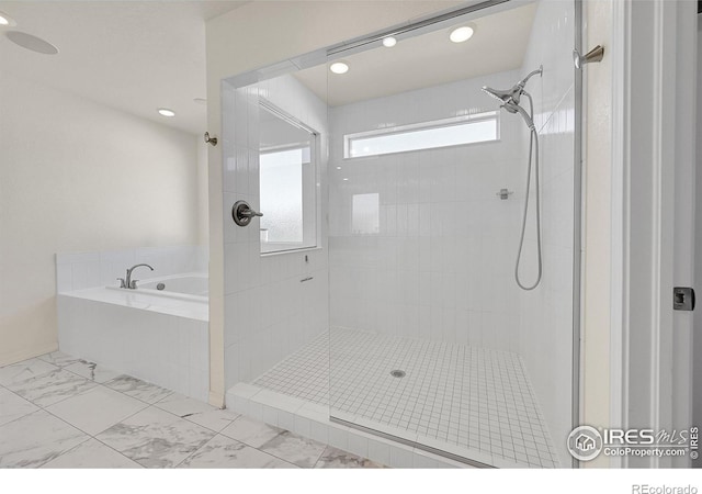 bathroom with separate shower and tub