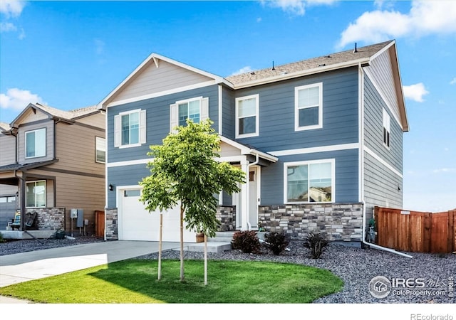 craftsman-style home with a front lawn and a garage