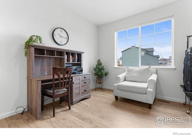 office with light hardwood / wood-style flooring