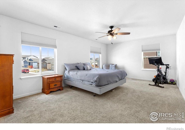 bedroom with light carpet and ceiling fan