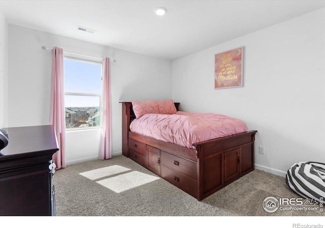 bedroom with light colored carpet