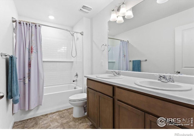 full bathroom with toilet, vanity, and shower / bath combo with shower curtain