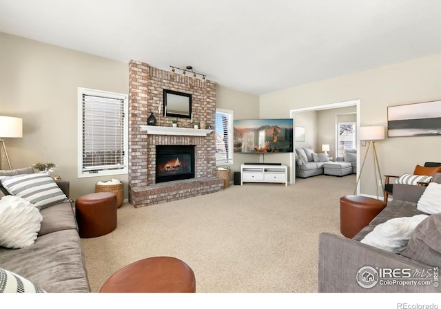 carpeted living room featuring a brick fireplace