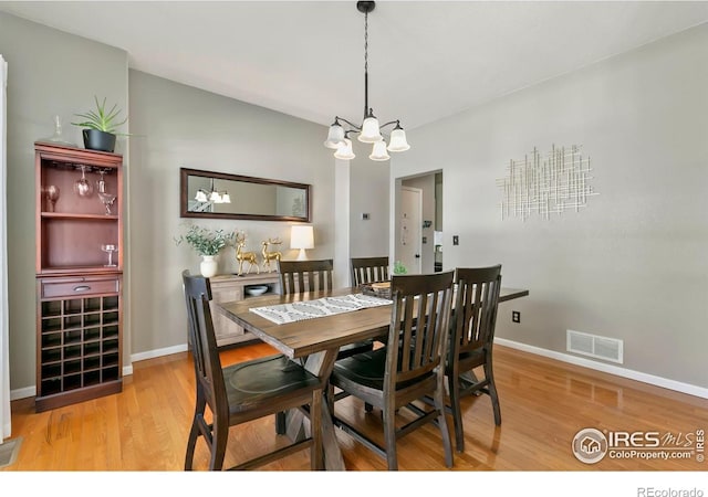 dining room featuring a chandelier and light wood-type flooring