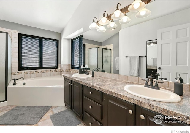 bathroom featuring lofted ceiling, shower with separate bathtub, tile patterned flooring, and vanity