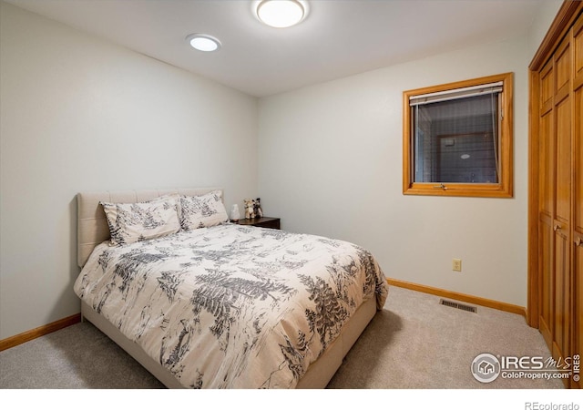 bedroom featuring light colored carpet and a closet