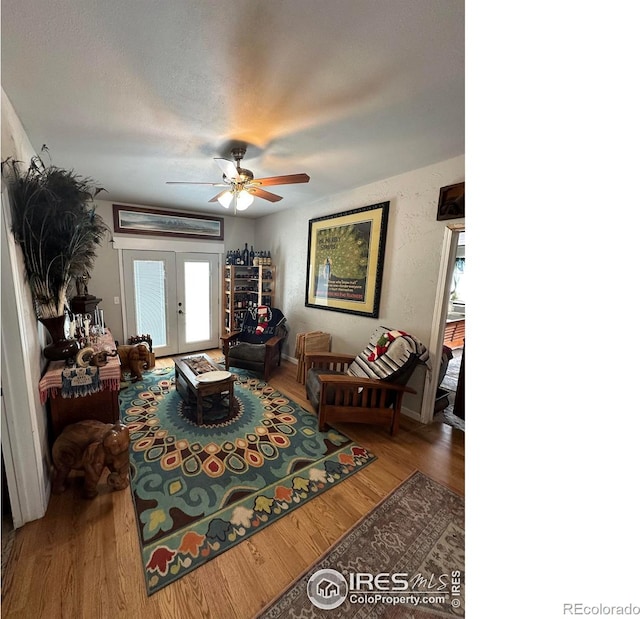 living room with french doors, ceiling fan, and hardwood / wood-style floors