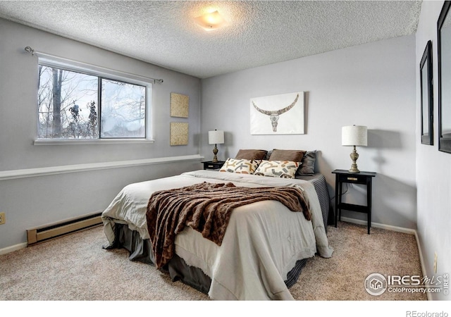 carpeted bedroom with a baseboard radiator and a textured ceiling