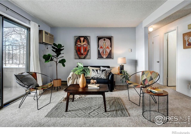 carpeted living room featuring a wall mounted air conditioner and a textured ceiling