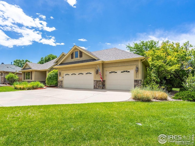 view of front of home with a garage and a front lawn