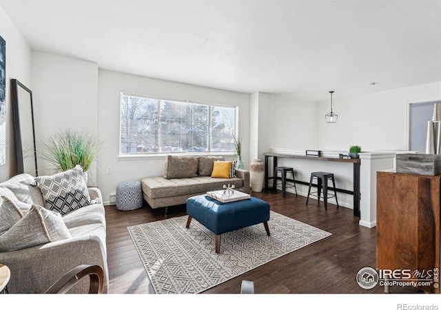 living room featuring baseboards and wood finished floors