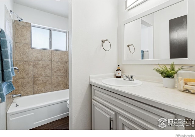 full bathroom featuring shower / bath combination, wood finished floors, and vanity