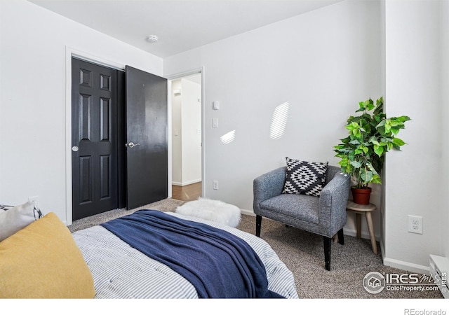 bedroom featuring carpet and baseboards