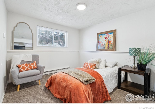 carpeted bedroom with a baseboard radiator and a textured ceiling