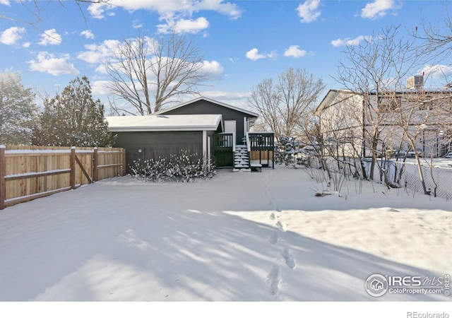 snowy yard with fence